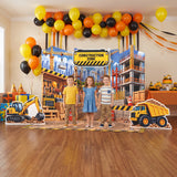Kids at a construction birthday party in front of the FoldWow Construction Zone backdrop