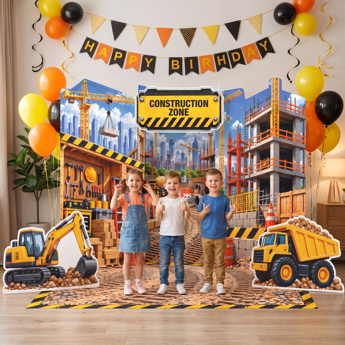 Kids smiling at a dump truck birthday party with the FoldWow Construction Zone backdrop